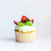 white and yellow cupcake with fruit toppings
