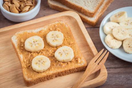 Bread with peanut butter and banana on plate